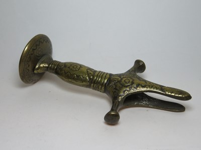 Lot 103 - A BRASS TULWAR HILT