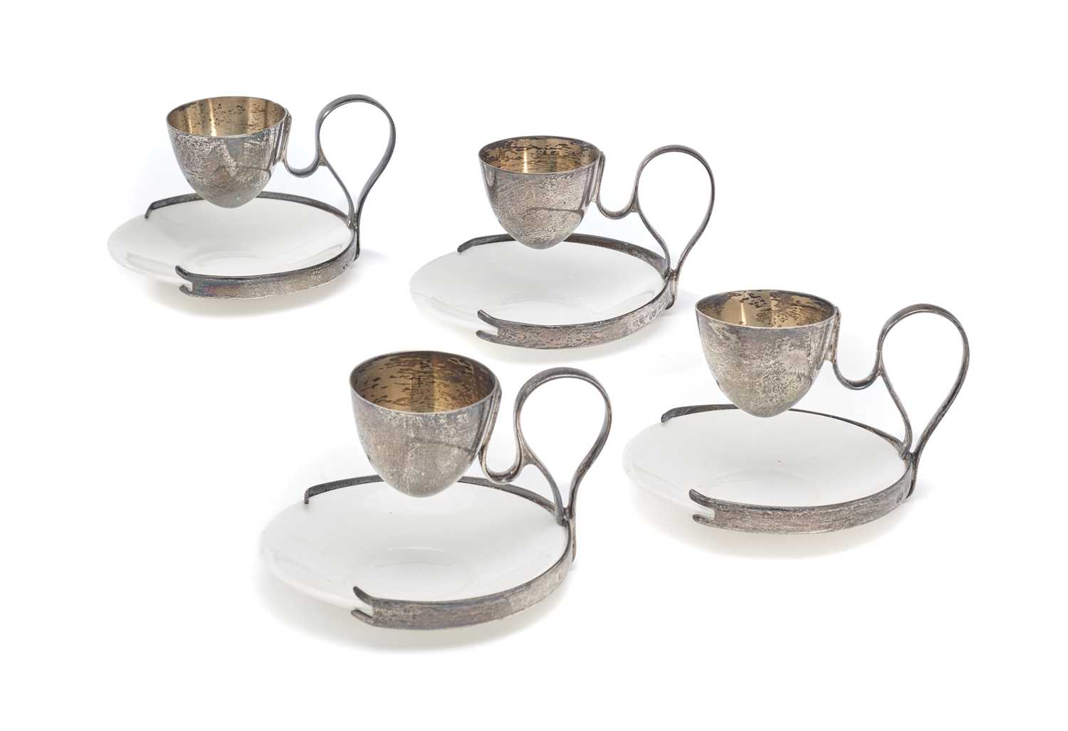 Lot 563 - A SET OF FOUR EDWARDIAN SILVER PATENT EGG CUP STANDS, ALFRED CLARK, LONDON, 1906