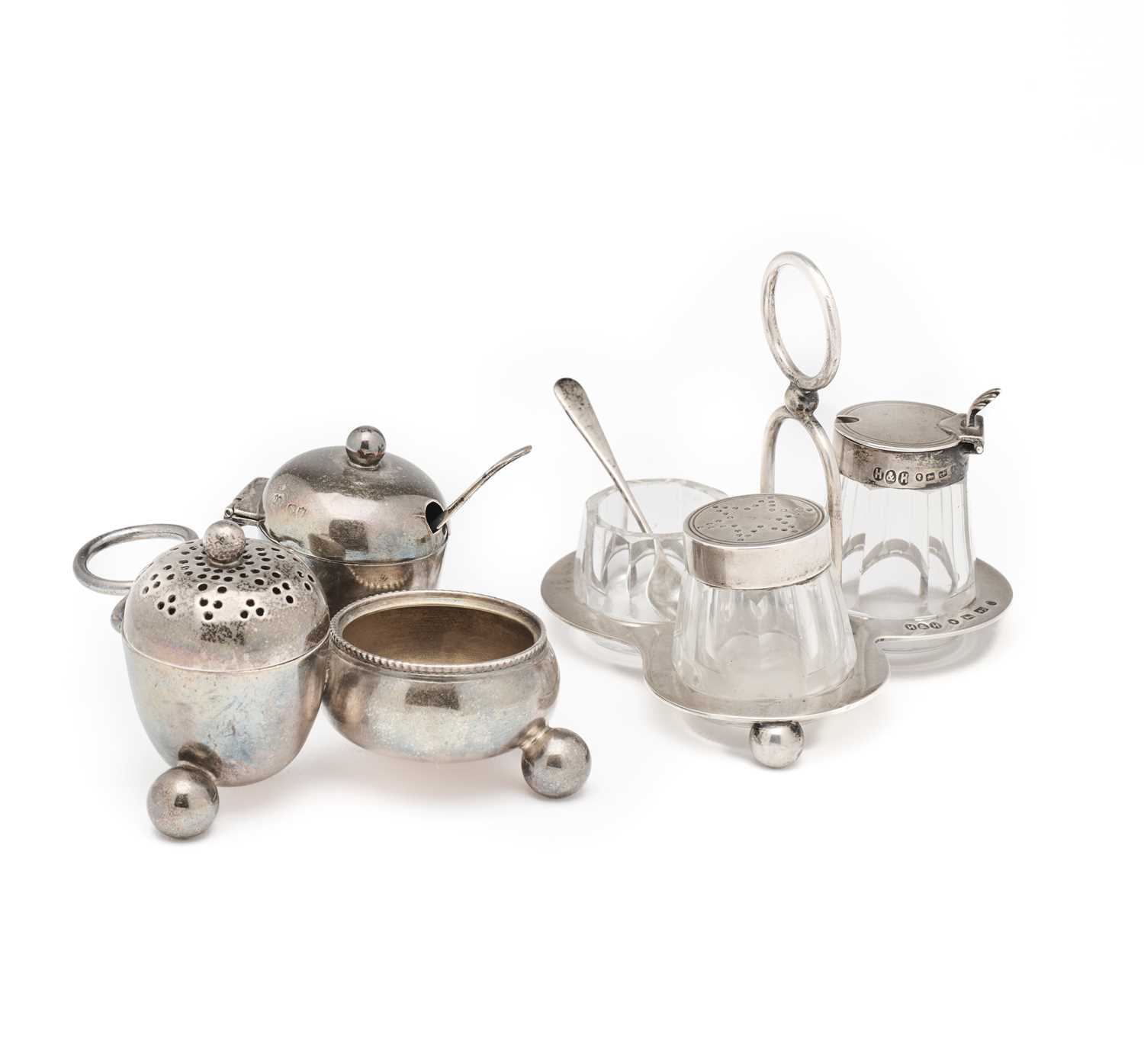 Lot 569 - TWO VICTORIAN SILVER THREE-PIECE CRUET STANDS IN THE MANNER OF CHRISTOPHER DRESSER