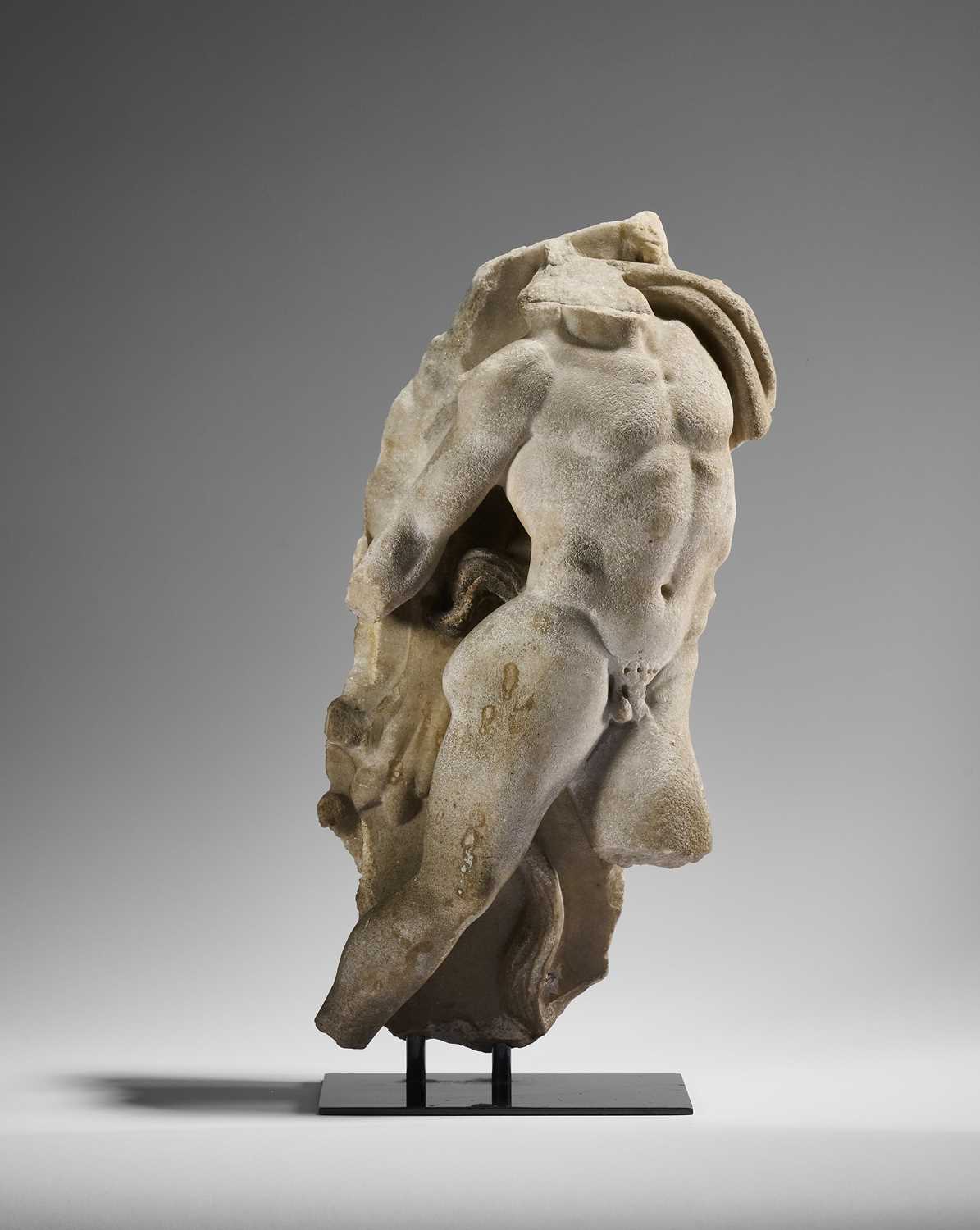 Lot 80 - A ROMAN MARBLE RELIEF FRAGMENT DEPICTING A DANCING SATYR, 2ND/3RD CENTURY A.D.