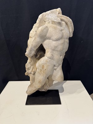 Lot 80 - A ROMAN MARBLE RELIEF FRAGMENT DEPICTING A DANCING SATYR, 2ND/3RD CENTURY A.D.