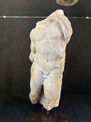 Lot 80 - A ROMAN MARBLE RELIEF FRAGMENT DEPICTING A DANCING SATYR, 2ND/3RD CENTURY A.D.