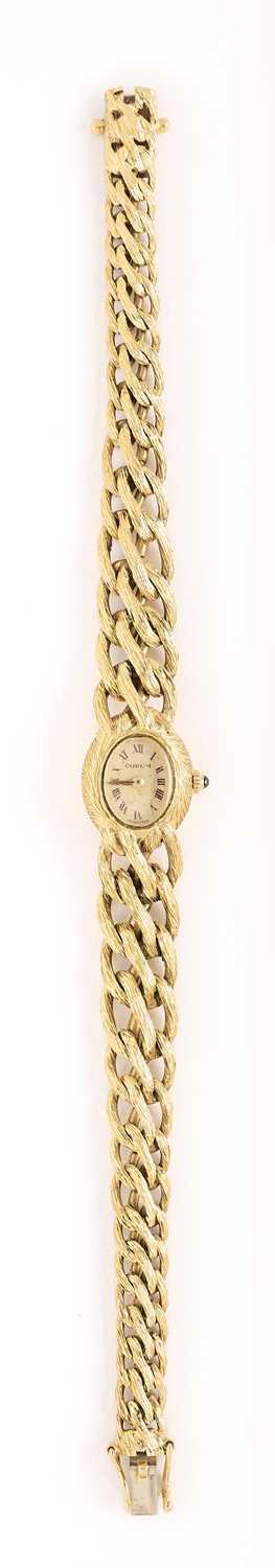 Lot 534 - CORUM: LADY'S GOLD BRACELET WATCH, SWISS, CIRCA 1988