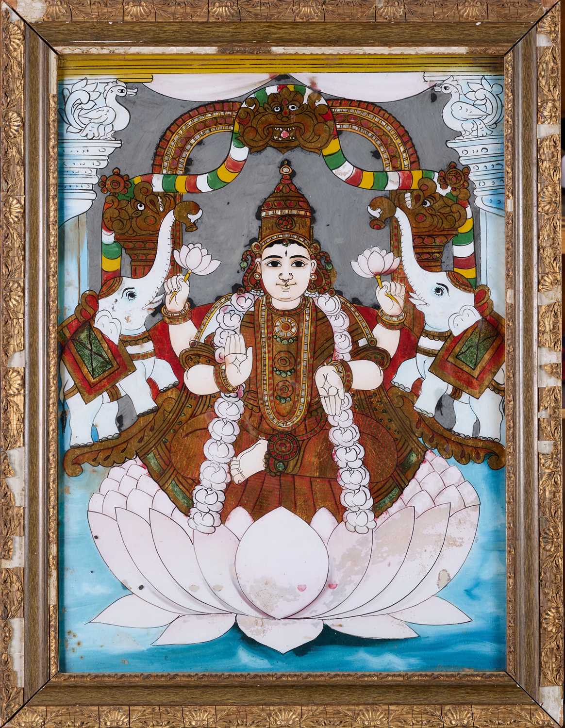 Lot 83 - A REVERSE GLASS PAINTING OF GAJALAKSHMI, TANJORE (THANJAVUR), SOUTH INDIA, CIRCA 1900