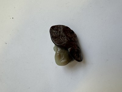 Lot 68 - A CHINESE CARVED CELADON AND RUSSET JADE 'FROG AND LOTUS' GROUP, QING DYNASTY (1644-1911)