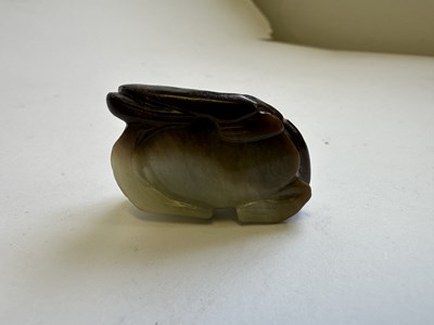 Lot 68 - A CHINESE CARVED CELADON AND RUSSET JADE 'FROG AND LOTUS' GROUP, QING DYNASTY (1644-1911)