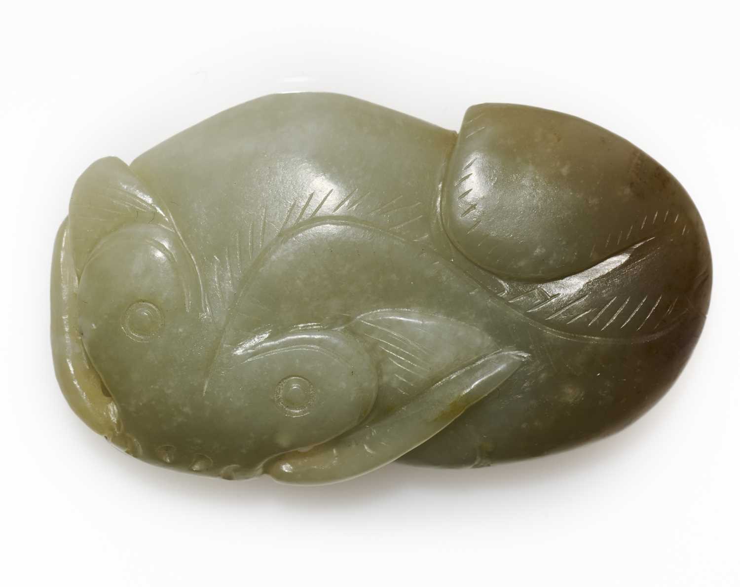 Lot 76 - A CHINESE CARVED CELADON AND RUSSET JADE CAT FISH, QING DYNASTY (1644-1911)