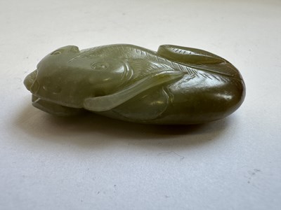 Lot 76 - A CHINESE CARVED CELADON AND RUSSET JADE CAT FISH, QING DYNASTY (1644-1911)