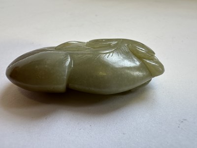 Lot 76 - A CHINESE CARVED CELADON AND RUSSET JADE CAT FISH, QING DYNASTY (1644-1911)
