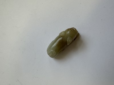 Lot 64 - A CHINESE CARVED JADE HOUND, QING DYNASTY (1644-1911)
