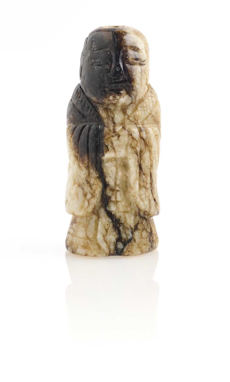 Lot 65 - A CHINESE CREAM AND BLACK JADE FIGURE, MING DYNASTY (1368-1644)