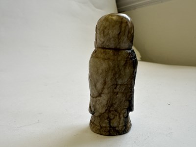 Lot 65 - A CHINESE CREAM AND BLACK JADE FIGURE, MING DYNASTY (1368-1644)