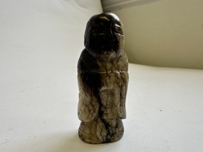 Lot 65 - A CHINESE CREAM AND BLACK JADE FIGURE, MING DYNASTY (1368-1644)
