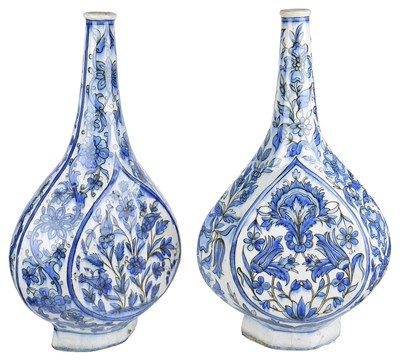 Lot 227 - â€¡A NEAR PAIR OF QAJAR BLUE AND WHITE BOTTLES