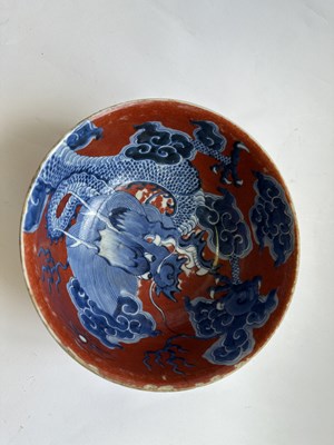 Lot 12 - A CHINESE RED-GROUND BLUE AND WHITE 'DRAGON' BOWL, QING DYNASTY, KANGXI PERIOD (1662-1722)