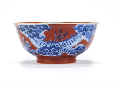 Lot 12 - A CHINESE RED-GROUND BLUE AND WHITE 'DRAGON' BOWL, QING DYNASTY, KANGXI PERIOD (1662-1722)