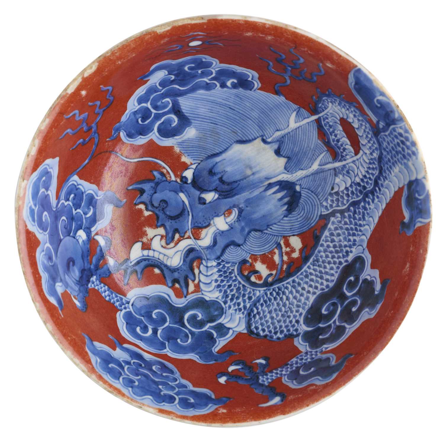 Lot 12 - A CHINESE RED-GROUND BLUE AND WHITE 'DRAGON' BOWL, QING DYNASTY, KANGXI PERIOD (1662-1722)