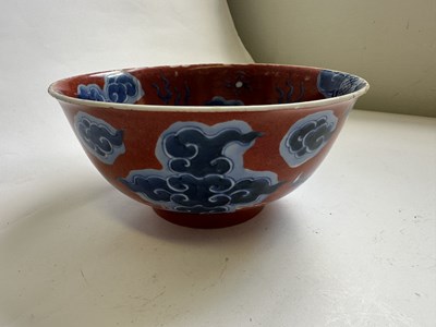 Lot 12 - A CHINESE RED-GROUND BLUE AND WHITE 'DRAGON' BOWL, QING DYNASTY, KANGXI PERIOD (1662-1722)
