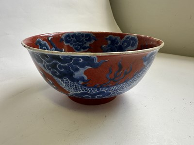 Lot 12 - A CHINESE RED-GROUND BLUE AND WHITE 'DRAGON' BOWL, QING DYNASTY, KANGXI PERIOD (1662-1722)