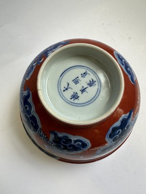 Lot 12 - A CHINESE RED-GROUND BLUE AND WHITE 'DRAGON' BOWL, QING DYNASTY, KANGXI PERIOD (1662-1722)