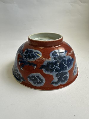 Lot 12 - A CHINESE RED-GROUND BLUE AND WHITE 'DRAGON' BOWL, QING DYNASTY, KANGXI PERIOD (1662-1722)