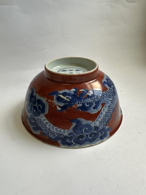 Lot 12 - A CHINESE RED-GROUND BLUE AND WHITE 'DRAGON' BOWL, QING DYNASTY, KANGXI PERIOD (1662-1722)