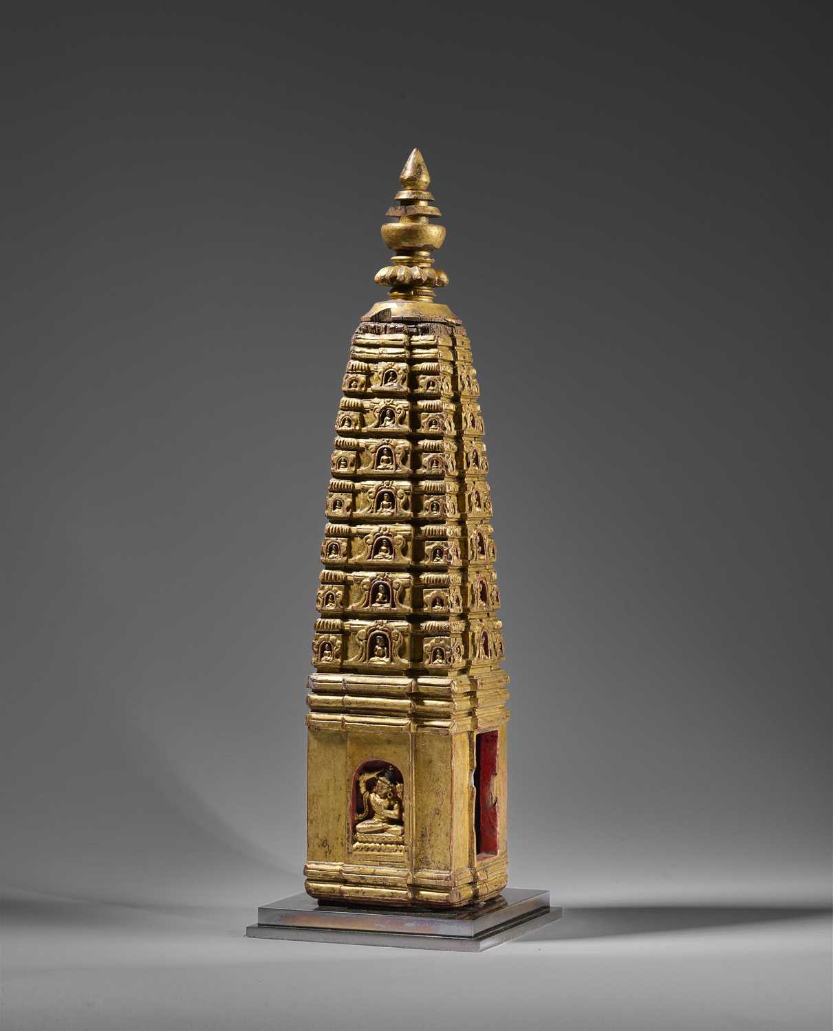 Lot 140 - A PALA GILT WOOD MODEL OF THE MAHABODHI SHRINE, BODH GAYA, INDIA, CIRCA 11TH CENTURY