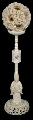 Lot 258 - ~A CHINESE IVORY PUZZLE BALL ON STAND