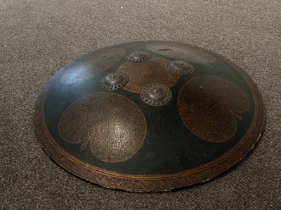 Lot 128 - AN HIDE SHIELD (DHAL), NORTHERN INDIA, 19TH CENTURY