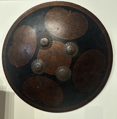 Lot 128 - AN HIDE SHIELD (DHAL), NORTHERN INDIA, 19TH CENTURY