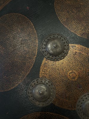 Lot 128 - AN HIDE SHIELD (DHAL), NORTHERN INDIA, 19TH CENTURY