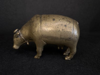 Lot 191 - A BRONZE RITUAL SPRINKLER IN THE FORM OF A COW, INDIA, CIRCA 17TH CENTURY