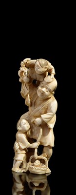 Lot 272 - ~A JAPANESE IVORY OKIMONO OF A FARMER AND HIS SONS PICKING FRUIT