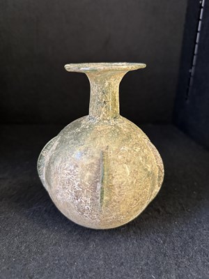 Lot 66 - A ROMAN PALE GREEN GLASS SPRINKLER FLASK, CIRCA 3RD-4TH CENTURY A.D.