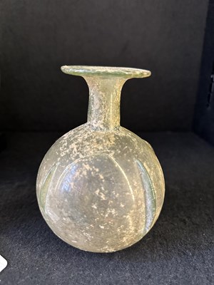Lot 66 - A ROMAN PALE GREEN GLASS SPRINKLER FLASK, CIRCA 3RD-4TH CENTURY A.D.