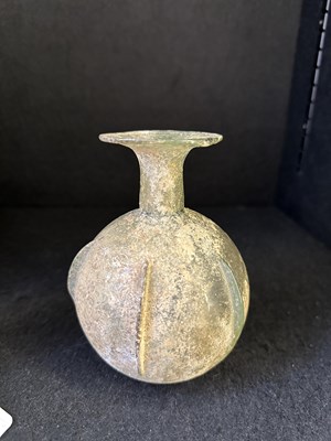Lot 66 - A ROMAN PALE GREEN GLASS SPRINKLER FLASK, CIRCA 3RD-4TH CENTURY A.D.