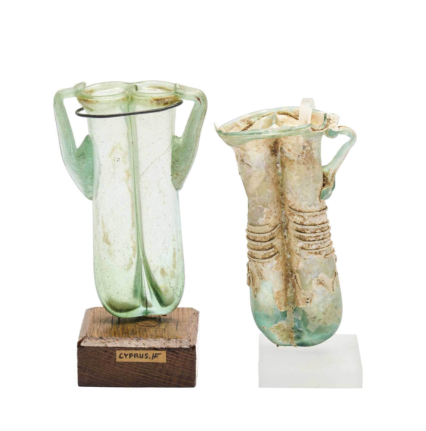 Lot 71 - TWO ROMAN GREEN GLASS DOUBLE BALSAMARIA, CIRCA 4TH CENTURY A.D.