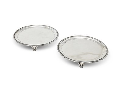 Lot 251 - A PAIR GEORGE III SILVER SALVERS, JOHN MEWBURN, LONDON, 1817