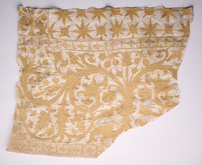Lot 284 - AN INDO-PORTUGUESE SILK EMBROIDERED COTTON COVERLET FRAGMENT, BENGAL, CIRCA 1600