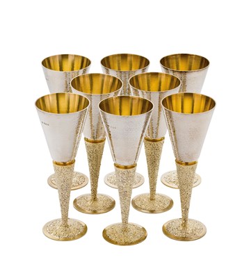 Lot 71 - A SET OF EIGHT PARCEL-GILT-SILVER WINE GOBLETS