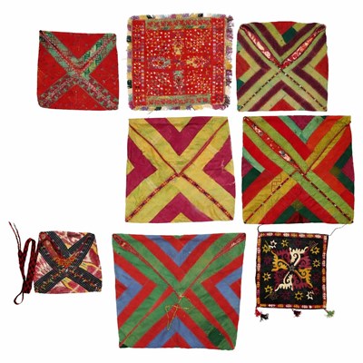 Lot 145 - AN EMBROIDERED TURKMAN BROADCLOTH TRAY COVER, A PANEL AND SEVEN POUCHES (BUKCHA), CIRCA 1900