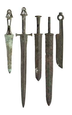 Lot 214 - FIVE  BRONZE DAGGERS, MIDDLE  AND FAR EASTERN, CIRCA 1,500-700 B.C. AND LATER AND A TRIBAL AXE