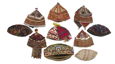 Lot 192 - A COLLECTION OF TEN EMBROIDERED AND DECORATED HATS, UZBEKISTAN, AFGHANISTAN, PAKISTAN, 20TH CENTURY