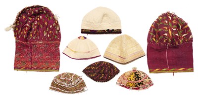 Lot 114 - EIGHT TURKMAN AND CENTRAL ASIAN HATS, LATE 19TH, AND 20TH CENTURIES