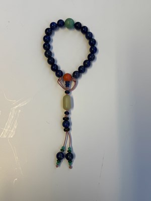 Lot 25 - A CHINESE LAPIS LAZULI PRAYER BRACELET, QING DYNASTY (1644-1911)
