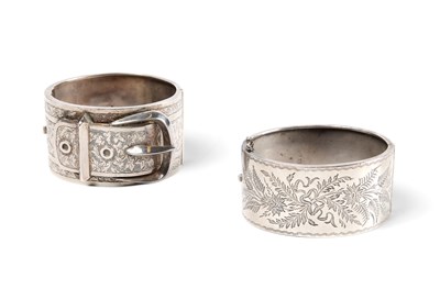 Lot 372 - TWO HINGED SILVER BANGLES, 1883 & 1909