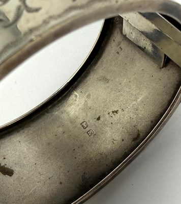 Lot 372 - TWO HINGED SILVER BANGLES, 1883 & 1909