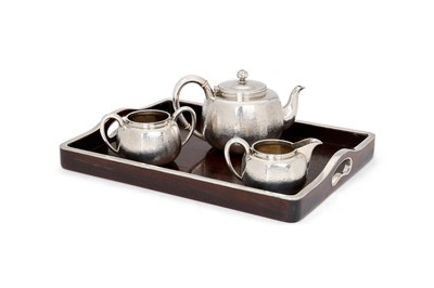 Lot 68 - A JAPANESE SILVER THREE-PIECE TEA SET ON SILVER-MOUNTED WOOD TRAY, MIYAMOTO SHOKO, TOKYO, CIRCA 1925
