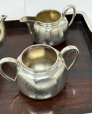 Lot 68 - A JAPANESE SILVER THREE-PIECE TEA SET ON SILVER-MOUNTED WOOD TRAY, MIYAMOTO SHOKO, TOKYO, CIRCA 1925