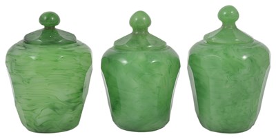 Lot 70 - A SET OF THREE PEKING GLASS JARS AND COVERS